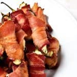 Bacon Wrapped Jalapeno Poppers Recipe - Bacon Wrapped Jalapeno Poppers make an appetizer that everyone loves! This easy recipe combines creamy cheeses, spicy jalapenos and crispy bacon for classic baked jalapeno poppers that are irresistible! // addapinch.com