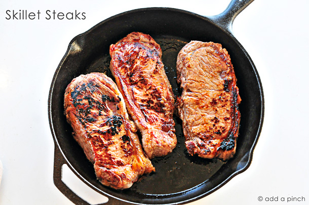 Skillet Steaks with Gorgonzola Herbed Butter - Nothing beats the sear of a steak cooked in a cast iron skillet! Topped with Gorgonzola Herbed Butter? Makes this skillet steak recipe out of this world! // addapinch.com