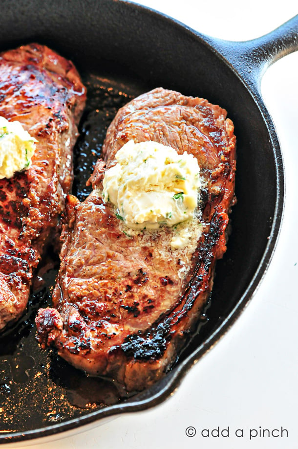 Skillet Steaks with Gorgonzola Herbed Butter - Nothing beats the sear of a steak cooked in a cast iron skillet! Topped with Gorgonzola Herbed Butter? Makes this skillet steak recipe out of this world! // addapinch.com