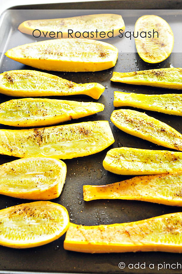 Summer squash is sliced lengthwise, seasoned and placed on metal baking pan 