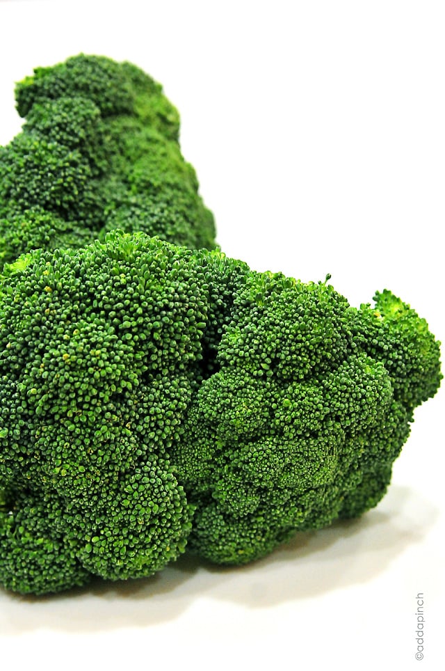 Raw broccoli on a white countertop.  