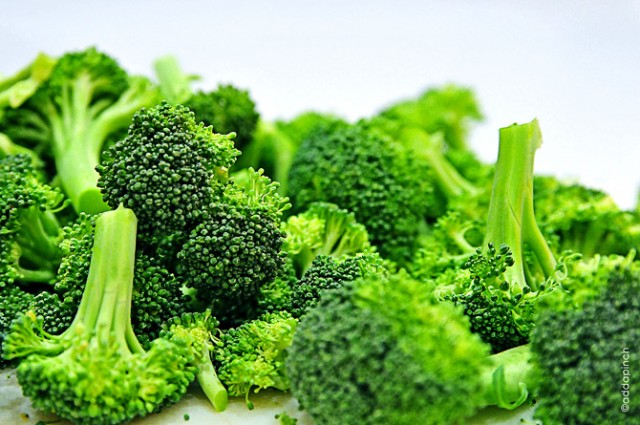 Fresh broccoli is cut into florets.