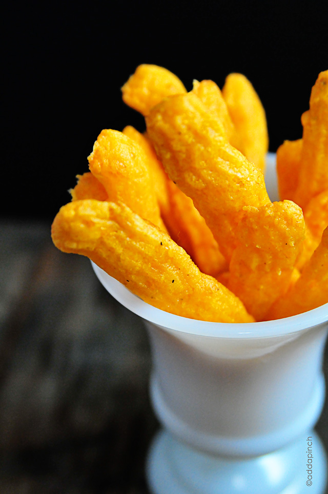 White footed milk glass cup with cheese straws 