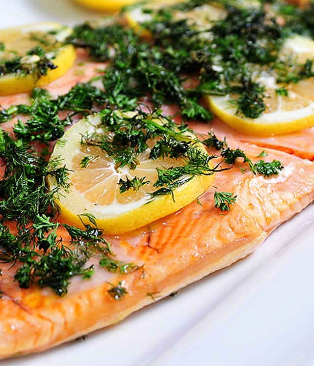 Baked salmon topped with lemon and fresh herbs. 