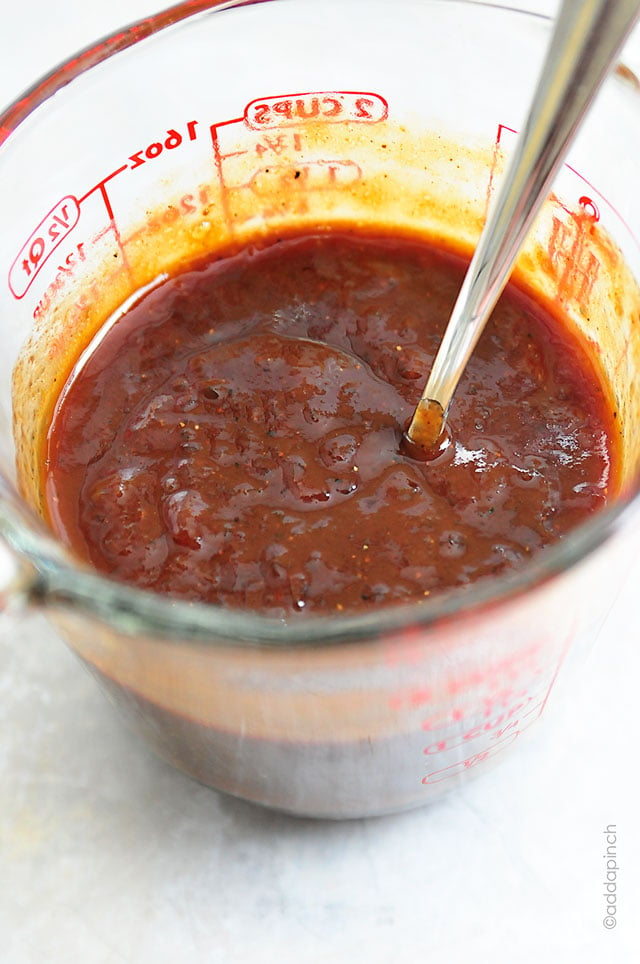 This Spicy Peach BBQ Sauce is a delicious combination of sweet peaches and spicy bbq sauce! Perfect on so many dishes, this is amazing on chicken and pork! // addapinch.com