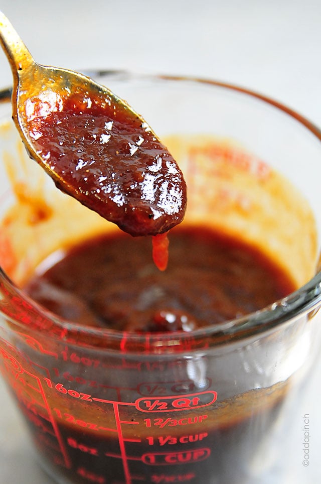 This Spicy Peach BBQ Sauce is a delicious combination of sweet peaches and spicy bbq sauce! Perfect on so many dishes, this is amazing on chicken and pork! //addapinch.com