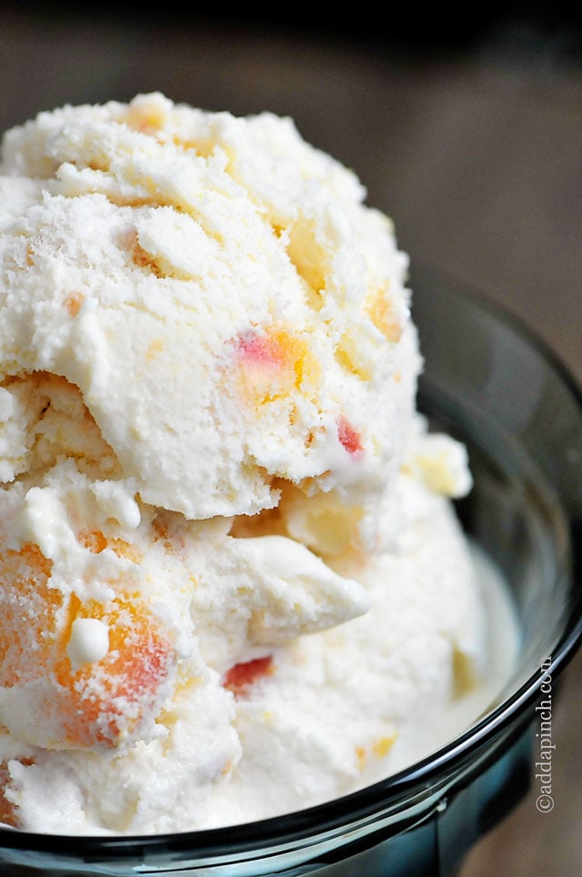 Large scoops of peach ice cream highlights large pieces of roasted peaches - ©addapinch.com
