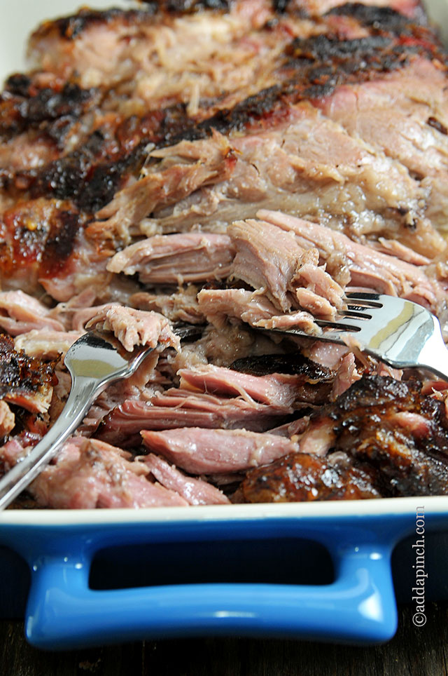 Blue casserole dish with pulled pork and two forks // addapinch.com
