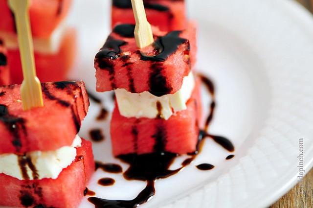 Watermelon Feta Bites drizzled with homemade Balsamic Glaze are speared with wooden party picks for serving // addapinch.com