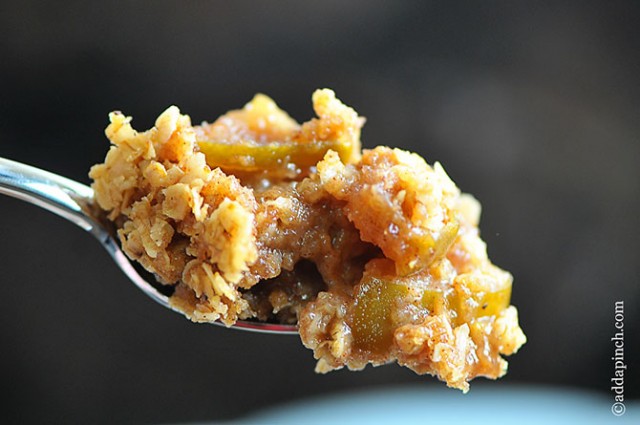 Apple Crisp with crunchy streusel topping on a stainless spoon. 