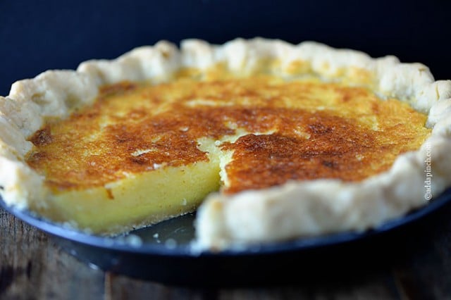 Buttermilk pie in a homemade pie crust with one slice removed.