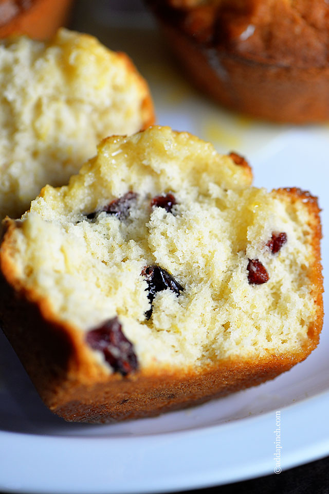 Cranberry Orange Muffins with cranberries shown inside - addapinch.com