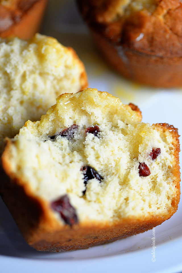 Closeup of muffins cut open so that cranberries show.