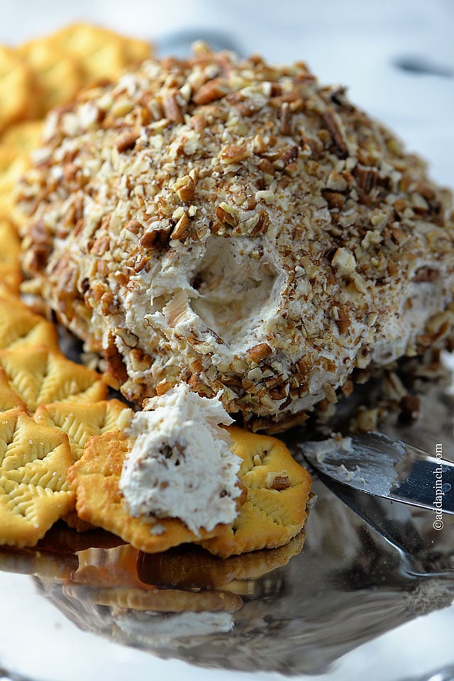 Chicken cheese ball on a silver platter with crackers.