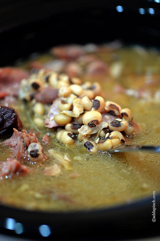 Black Eyed Peas make a Southern favorite and are traditionally served on New Year's Day to bring good luck. This recipe provides both stove-top and slow cooker methods! // addapinch.com