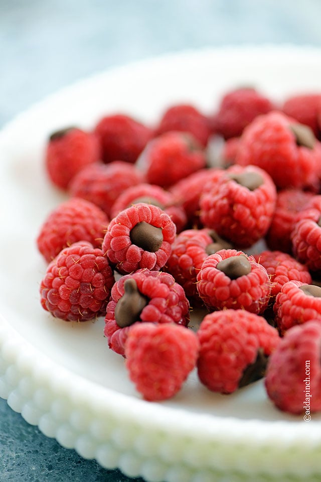 Chocolate Filled Raspberries on a white serving dish.