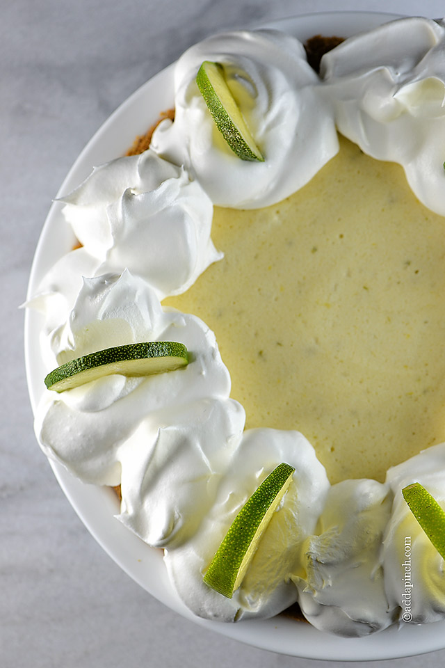 Closeup of pie with limes and whipped cream on marble countertop ©addapinch.com