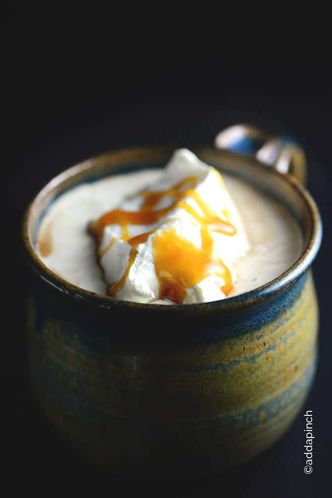 Salted Caramel Mocha Recipe in heavy handmade mug with whipped cream and caramel on top. // addapinch.com