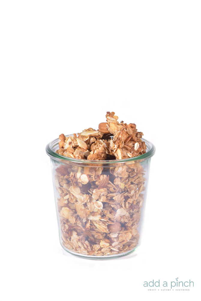 Honey Nut Granola Recipe - This honey nut granola recipe makes an easy, yet exceptional homemade granola. One recipe makes plenty for a week's worth of parfaits, sprinkles for ice cream, breakfast and snacks or even to share! // addapinch.com