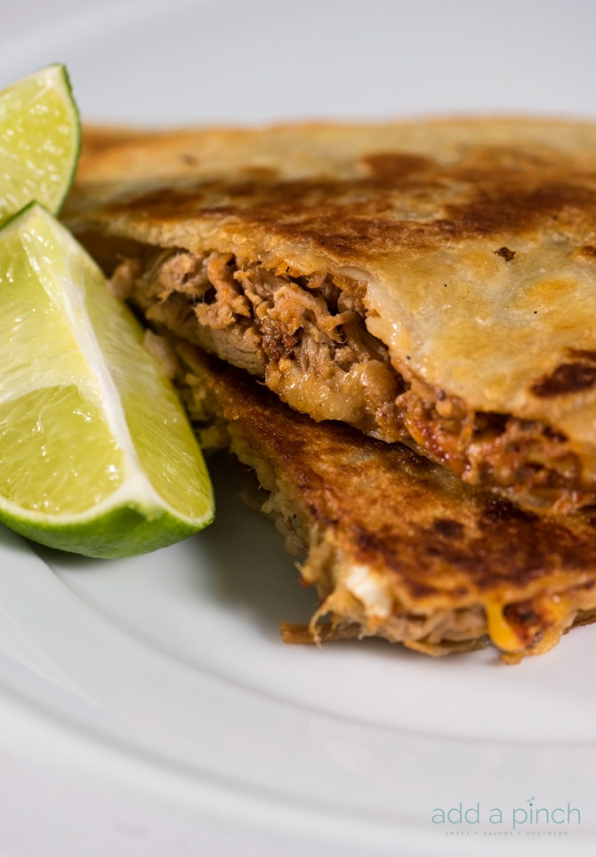 Pulled pork quesadillas make an all-time favorite leftover makeover the whole family loves! So simple and easy! // addapinch.com