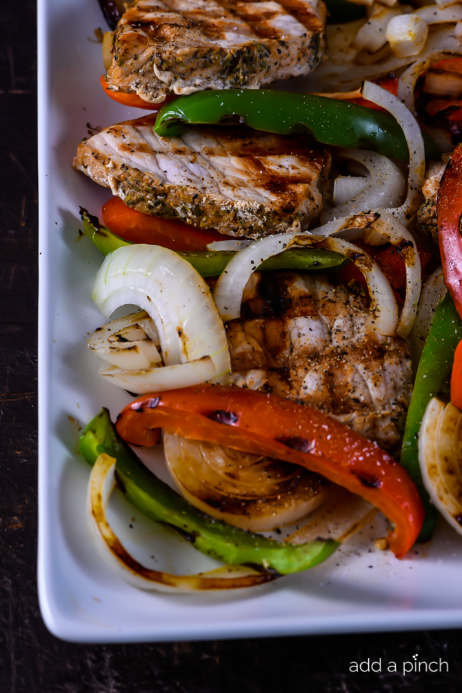 Grilled Pork Loin with Peppers and Onions makes a quick and easy dish perfect for weeknight or weekend meals! // addapinch.com