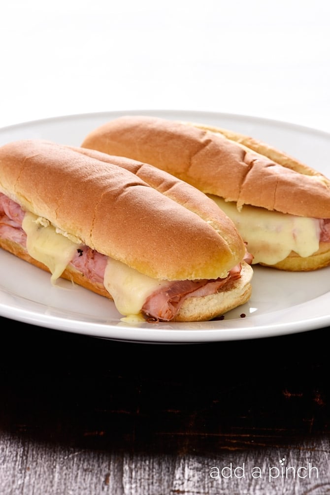 These simple ham sandwiches are perfect for a quick lunch or supper. Made of ham, cheese, spices, olive oil and vinegar, this isn't just any ham sandwich! // addapinch.com