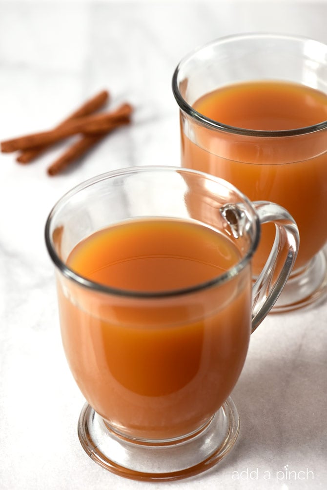 Caramel Apple Cider makes a delicious drink throughout the year, but especially during fall and winter! This quick and easy recipe gives instructions for a single mug, a gallon, as well as slow cooker instructions! It is a MUST have recipe! // addapinch.com