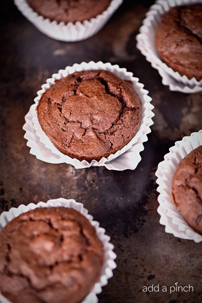 Pumpkin Chocolate Chocolate Chip Muffins make a special treat for breakfast, brunch or an afternoon snack! These are a definite fall favorite! // addapinch.com