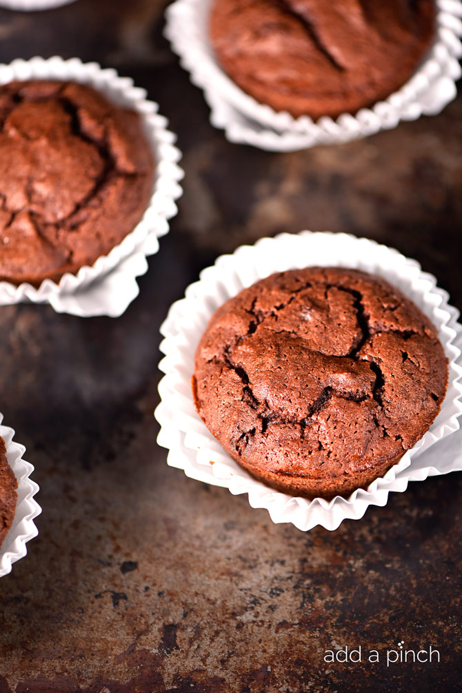 Pumpkin Chocolate Chocolate Chip Muffins make a special treat for breakfast, brunch or an afternoon snack! These are a definite fall favorite! // addapinch.com