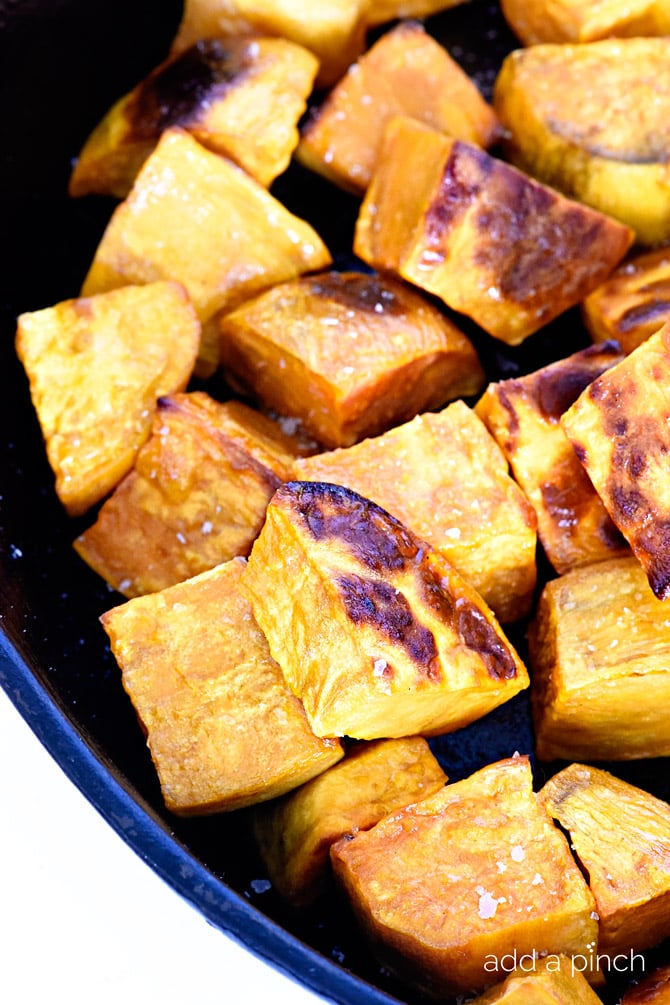 Skillet roasted sweet potatoes make a favorite side dish! Made with just a few ingredients, the skillet makes these sweet potatoes incredibly crisp, yet still tender. // addapinch.com