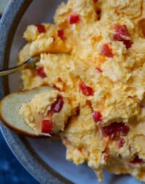 Southern Pimento Cheese Recipe - A staple spread in Southern home and parties, pimento cheese is a classic! Made with cheddar cheese, pimentos and a secret ingredient, this pimento cheese recipe is always a hit! // addapinch.com