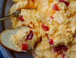 Southern Pimento Cheese Recipe - A staple spread in Southern home and parties, pimento cheese is a classic! Made with cheddar cheese, pimentos and a secret ingredient, this pimento cheese recipe is always a hit! // addapinch.com