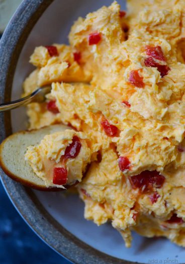 Southern Pimento Cheese Recipe - A staple spread in Southern home and parties, pimento cheese is a classic! Made with cheddar cheese, pimentos and a secret ingredient, this pimento cheese recipe is always a hit! // addapinch.com