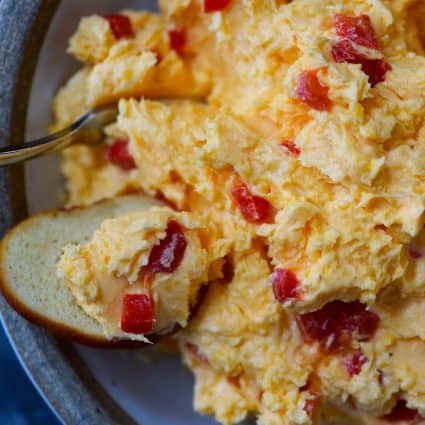 Southern Pimento Cheese Recipe - A staple spread in Southern home and parties, pimento cheese is a classic! Made with cheddar cheese, pimentos and a secret ingredient, this pimento cheese recipe is always a hit! // addapinch.com