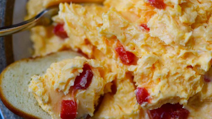 Southern Pimento Cheese Recipe - A staple spread in Southern home and parties, pimento cheese is a classic! Made with cheddar cheese, pimentos and a secret ingredient, this pimento cheese recipe is always a hit! // addapinch.com
