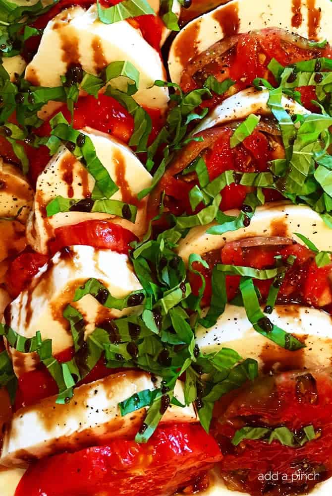 Caprese Salad with Balsamic Glaze Recipe - A classic caprese salad recipe with out of this world flavor. Topped with a sweet, yet tangy balsamic glaze to elevate every single bite! // addapinch.com