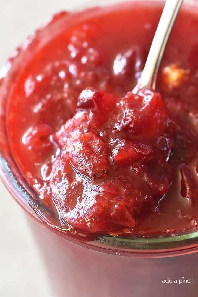 Classic Cranberry Sauce in bowl with spoon.  // addapinch.com