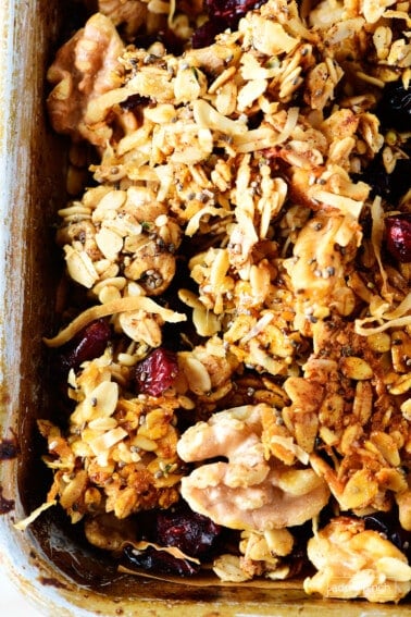 Photo of homemade granola on a baking sheet with a spatula.