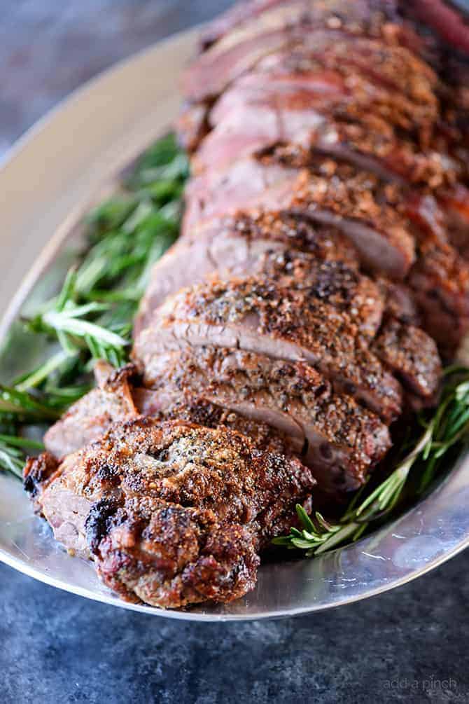 Cooked beef tenderloin on platter.