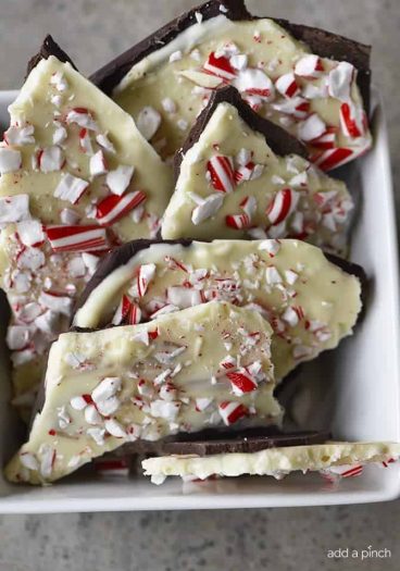 Homemade Peppermint Bark Recipe - Peppermint Bark makes a favorite holiday treat! This homemade peppermint bark recipe is made with layers of peppermint filled milk chocolate and white chocolate and then topped with peppermint candy. // addapinch.com
