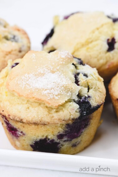 Blueberry Muffins Recipe - This easy, one bowl recipe makes the best blueberry muffins! Bursting with blueberries under a sparkling sugar topping! // addapinch.com