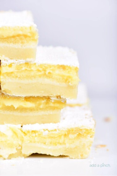 Easy Lemon Bars Recipe - This easy Lemon Bars recipe makes a delicious sweet treat! Layered onto a shortbread crust, this tart, yet sweet lemon bar is perfect for the lemon lover! // addapinch.com