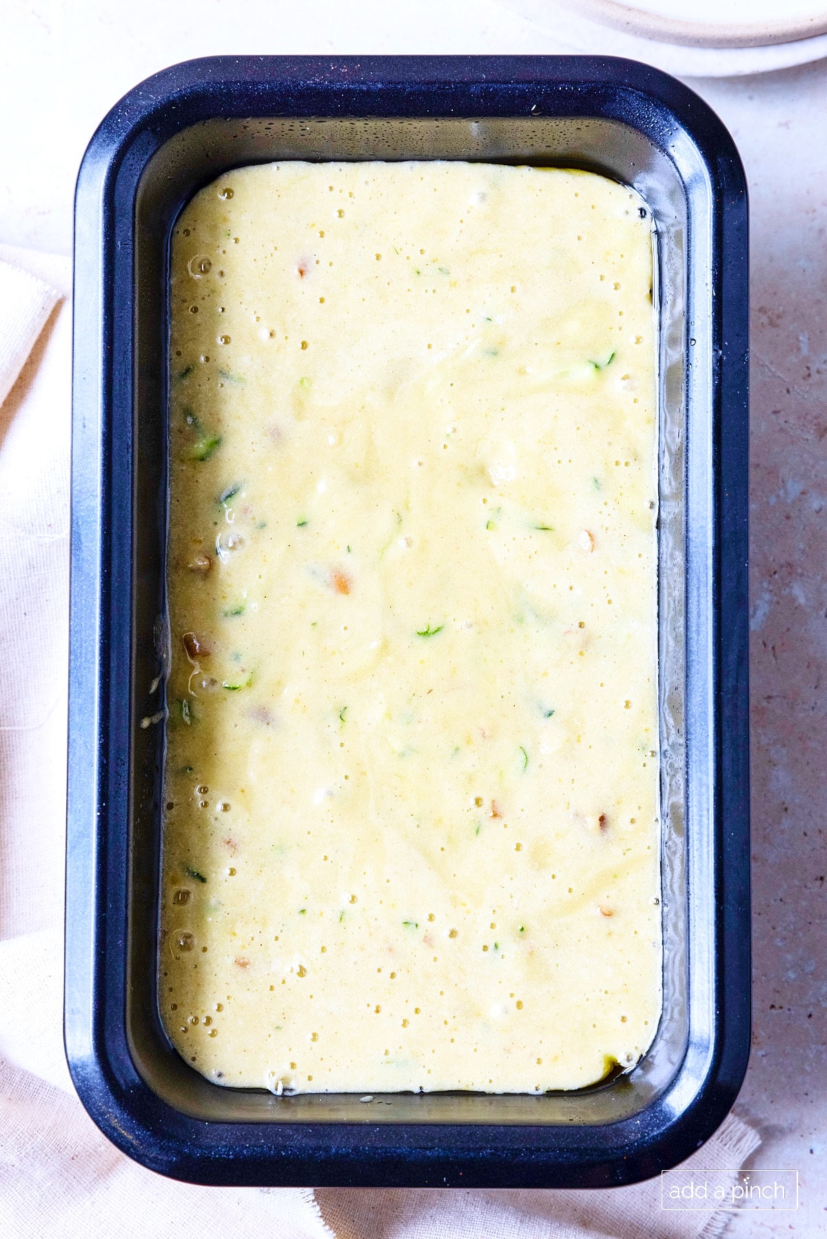Zucchini bread batter in a loaf pan ready to bake.