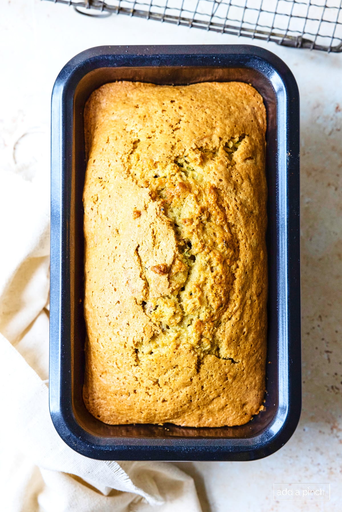 Baked zucchini bread in a loaf pan.