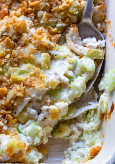 Hot chicken salad baked in a white baking dish.