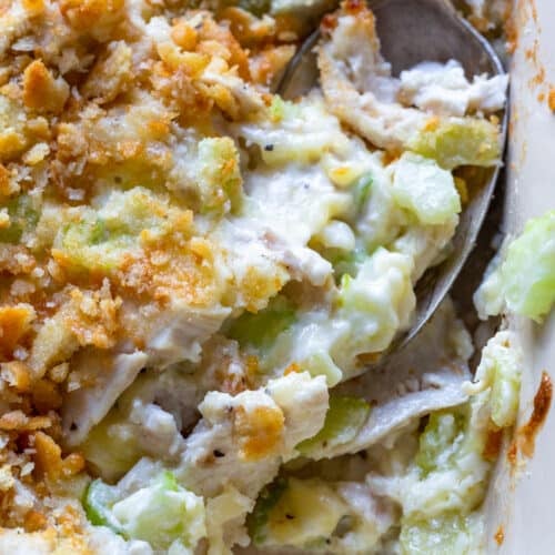 Hot chicken salad baked in a white baking dish.