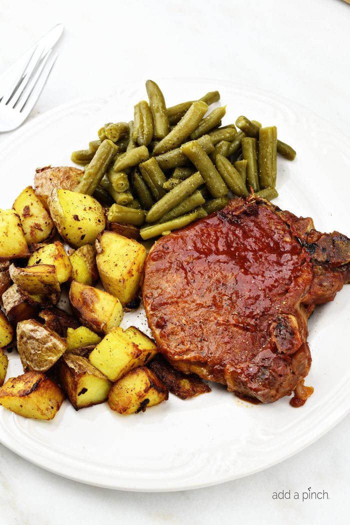 Slow Cooker BBQ Pork Chops - The slow cooker makes these pork chops tender and a family favorite! Only 5 minutes of prep time do  This is a favorite weekday meal! addapinch.com