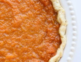 Overhead photograph of sweet potato pie in a homemade pie crust in white pie plate.