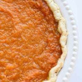 Overhead photograph of sweet potato pie in a homemade pie crust in white pie plate.