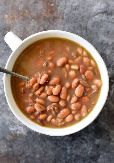 Pinto Beans Recipe - Slow cooked southern pinto beans that are a traditional favorite! Includes stove top, slow cooker and pressure cooker instructions! // addapinch.com